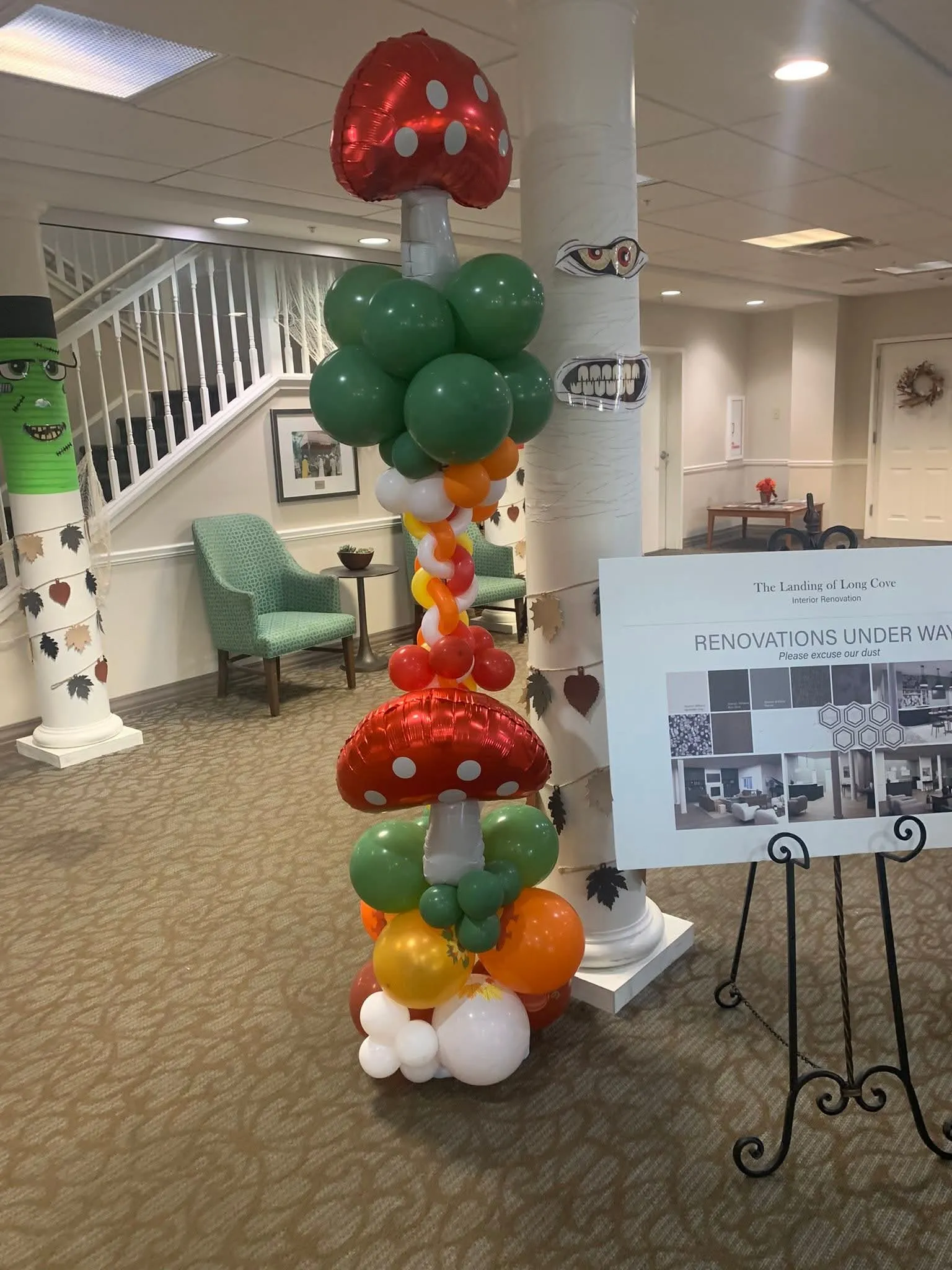 Balloon column with red polka-dot mushroom foil balloons and green, orange, yellow and white balloons